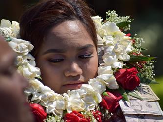 Girl with a flower necklace.